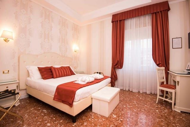 Classic hotel room with workspace at Navona Queen Rome for business travel and conference lodging.