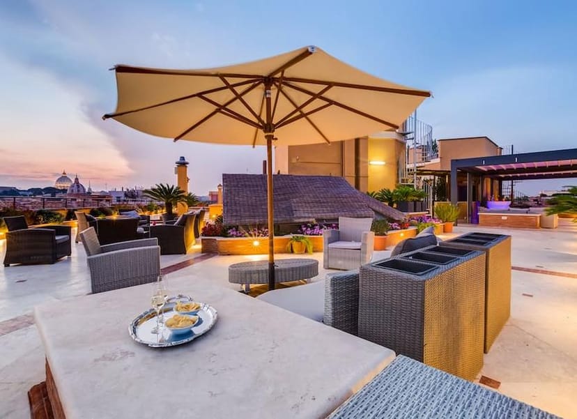 VIP welcome reception at Navona Queen Rome lounge featuring a panoramic skyline view.