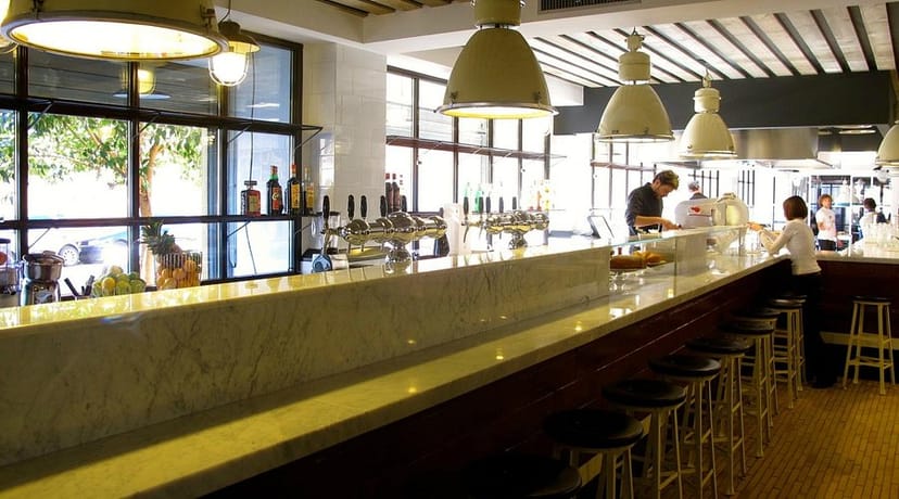 Polished Portofluviale bar space with natural light, perfect for networking events and receptions.