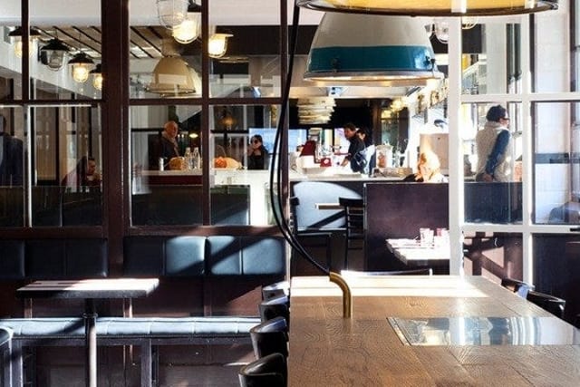 Industrial-chic Portofluviale restaurant venue with modular seating for networking and breakouts.