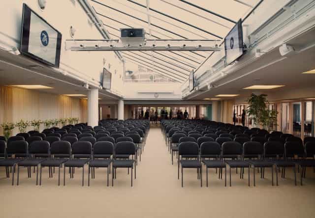 Modern coworking space with theater seating for corporate presentations and business events.