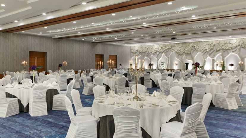Elegant Crowne Plaza ballroom with candelabra centerpieces for weddings and gala dinners.