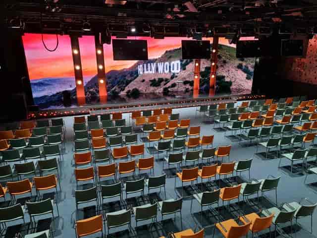 Gyllene Salen stage with LED backdrop and theater seating for corporate events and conferences.
