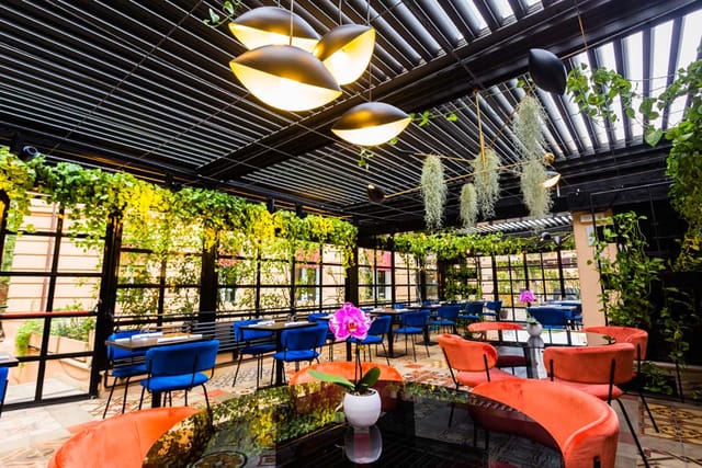 Biophilic event space at The Corner Roma with louvered ceiling for cocktail receptions or mixers.