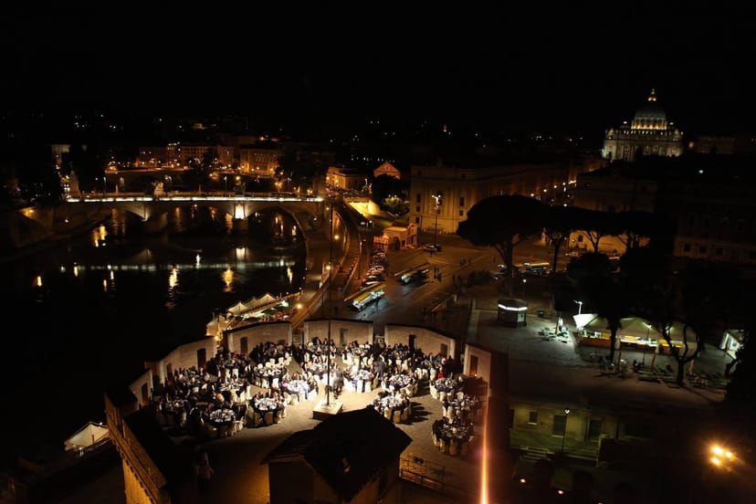 Open-air gala dinner at Le Terrazze Castel Sant'Angelo with iconic Roman backdrop.