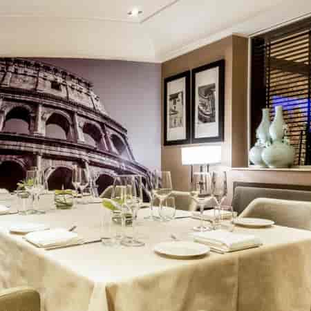 Private dining room with mural wall for corporate events and business meetings at I Sofà Bar.