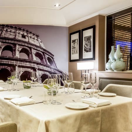 Private dining room with mural wall for corporate events and business meetings at I Sofà Bar.