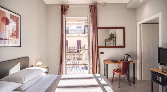 Boutique hotel suite with workspace and terrace for VIP business retreats and off-site meetings.