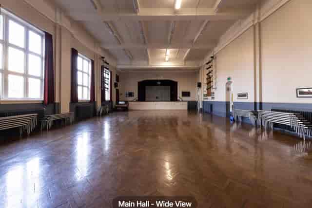 Main Hall event space with stage: versatile blank-canvas venue for corporate events and weddings.