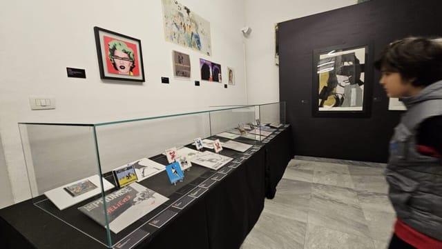 Warhol and Banksy exhibit in Sala Elsa Morante with professional vitrines for art gallery events.