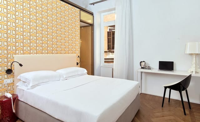 Boutique Centrale Palace bleisure guest room with dedicated workspace for corporate travel.