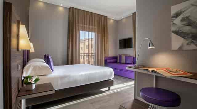 Modern hotel room at Sala Borghese with workspace, perfect for corporate lodging and business travel.