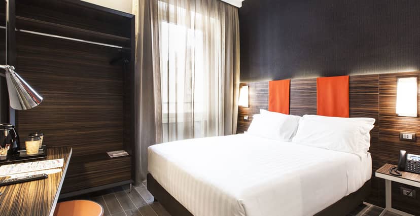 Modern hotel room at Sala Borghese, featuring compact workspace for business travel.