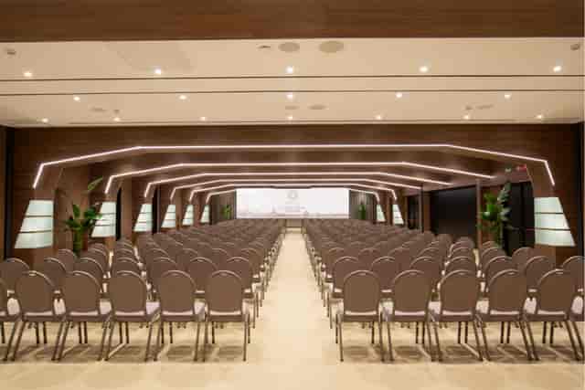 Modern ballroom with theater-style seating for corporate summits and keynote presentations.