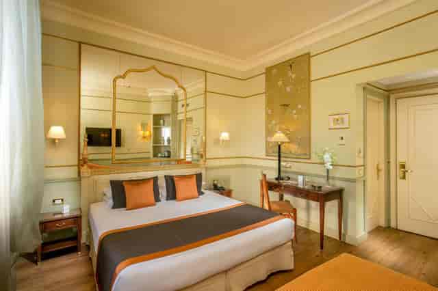 Upscale boutique hotel room with executive workspace for VIP speaker and corporate event stays.