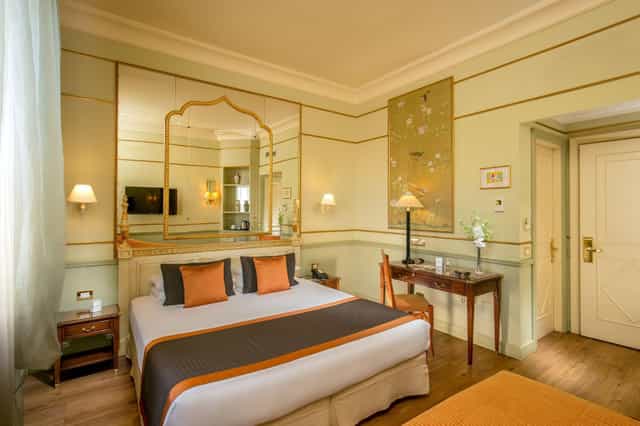 Upscale boutique hotel room with executive workspace for VIP speaker and corporate event stays.