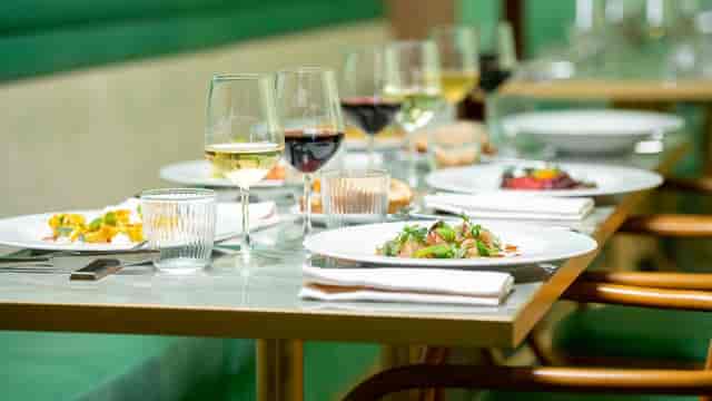 Corporate dinner setup at Ozio ai Parioli, featuring elegant table settings for business events.