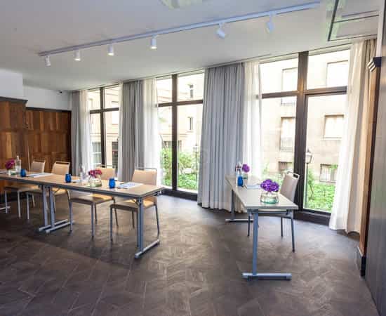 Classroom-style meeting room with natural light for professional workshops and corporate events.
