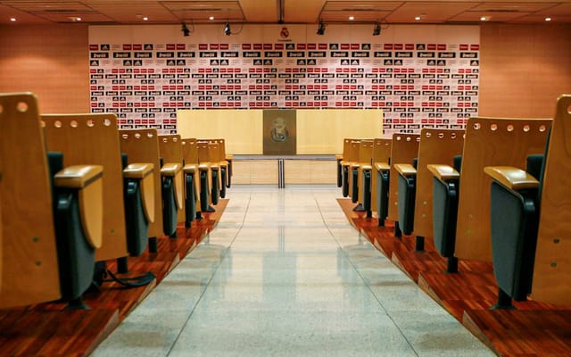 Bernabéu press conference room with branded backdrop for media events and sponsor showcases.