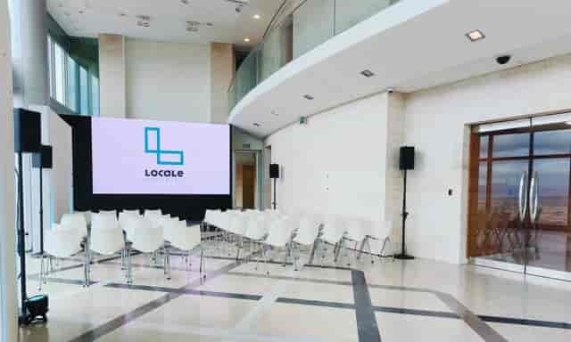 Theater-style meeting room at Torre Emperador Castellana with digital backdrop for corporate events.