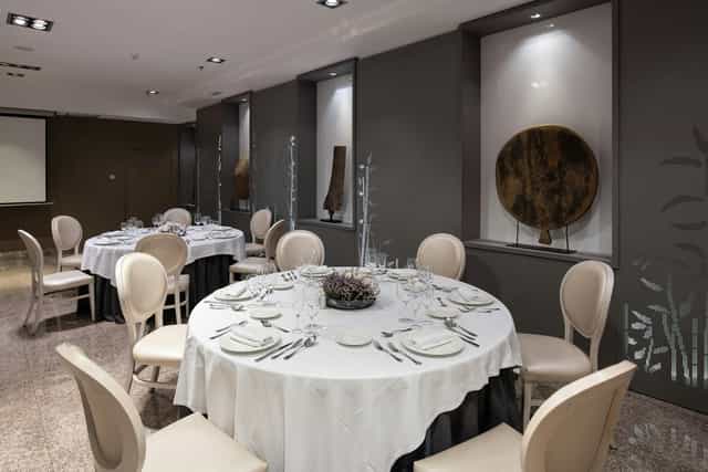 Banquet-ready Meeting Room Delicias with white linens for corporate dinners and social events.