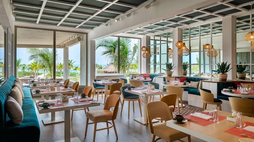 Modern beachfront restaurant with modular seating for corporate networking and social events.