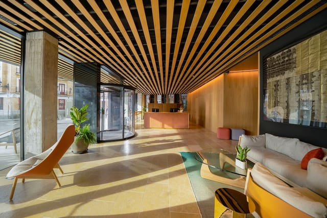 Modern hotel lobby lounge for business networking and corporate event breakout sessions.