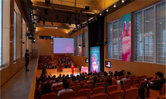 Corporate auditorium at Fundación Canal with tiered seating for high-impact speaker events.