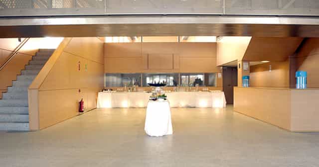 Modern coffee break setup in Fundación Canal atrium for corporate event or business conference.