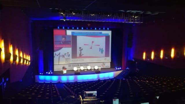 Sala Goya at Teatro Goya: Blue-lit tiered theater plenary setup for corporate events.