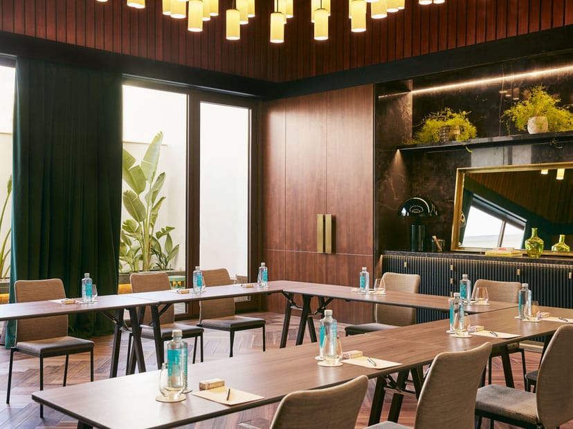 U-shaped boardroom with wood paneling for executive meetings and corporate strategy sessions.
