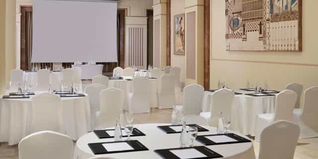 Banquet-style meeting setup at Oceans Events hall with round tables for professional conferences.