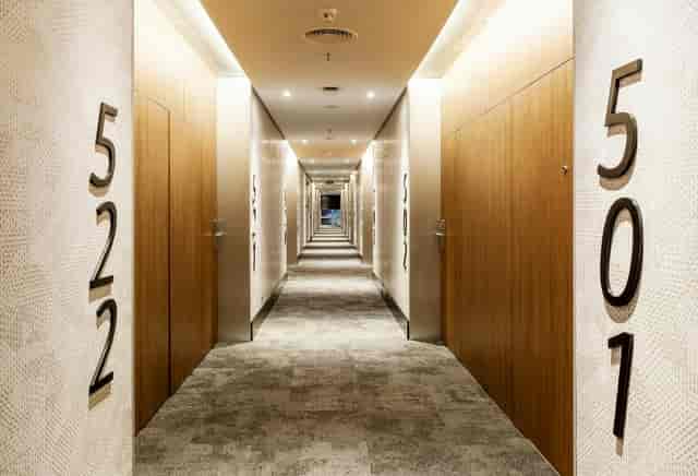 Modern hotel corridor with oversized signage for group events and venue wayfinding.
