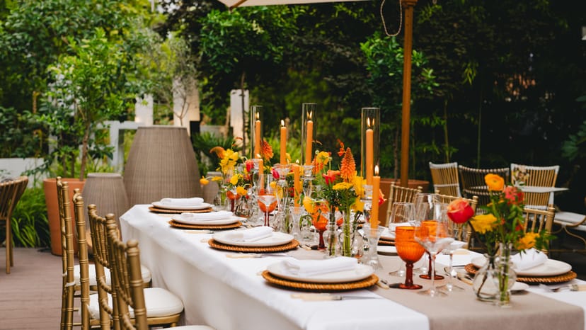 Elegant Garden Restaurant event setup at voco Madrid Retiro with gold accents and candlelight.