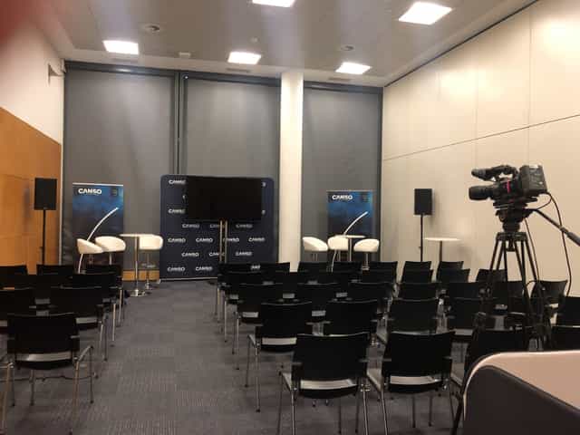 IFEMA Madrid breakout room with theater seating for panel discussion and professional AV equipment.