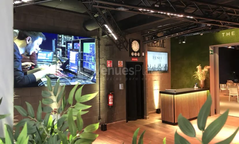 Modern event reception desk with LED video wall at Zenit The Studio for tech conferences.