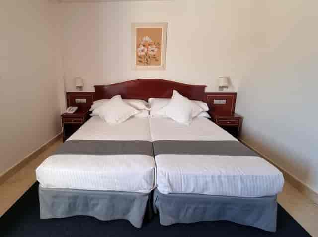 Hotel Gran Legazpi twin bedroom for cost-effective delegate housing and business event lodging.