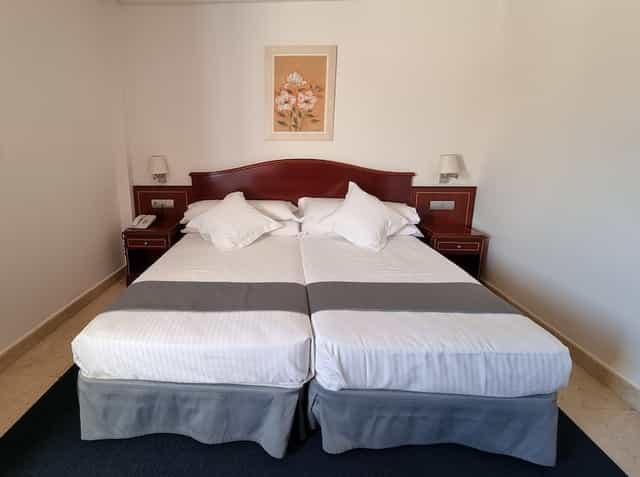 Hotel Gran Legazpi twin bedroom for cost-effective delegate housing and business event lodging.