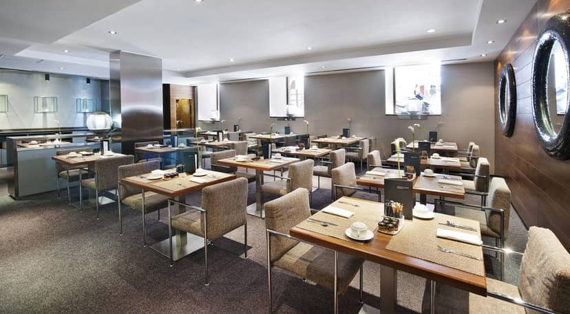 Modern AC Hotel Recoletos breakout room for business lunches and corporate events.
