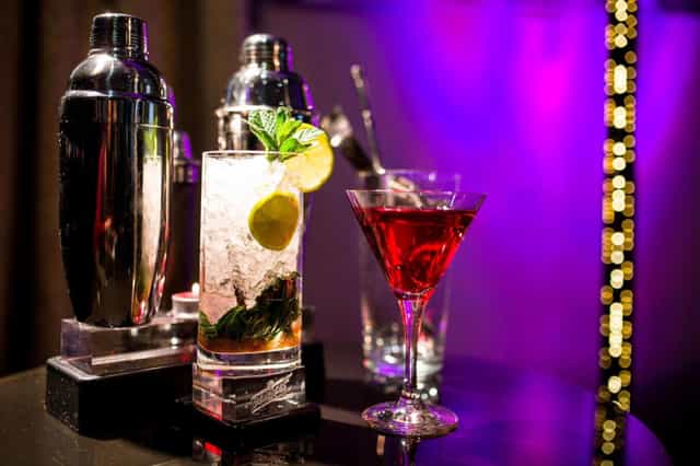 Premium beverage bar at AC Hotel Recoletos, expertly lit for an evening reception or event.
