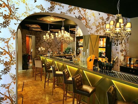 Private dining room with ambient chandeliers for upscale VIP receptions and networking events.