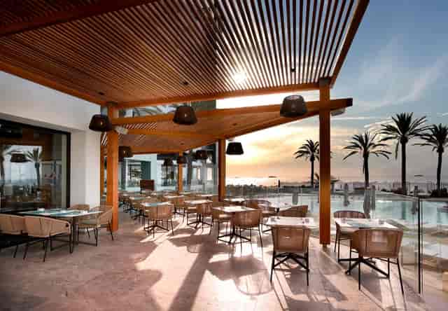 Outdoor restaurant at Hard Rock Hotel Ibiza with timber pergola for sunset events and gala dinners.