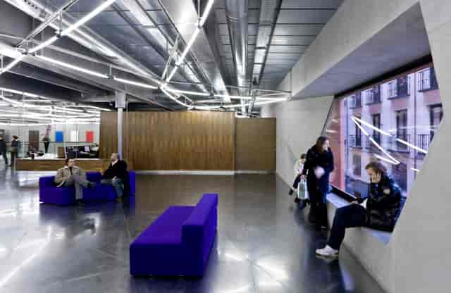Modern industrial breakout area at CaixaForum Madrid, ideal for networking and conference events.