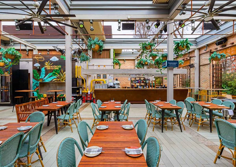 Industrial-chic Florida Park event space with overhead greenery for receptions and social gatherings.