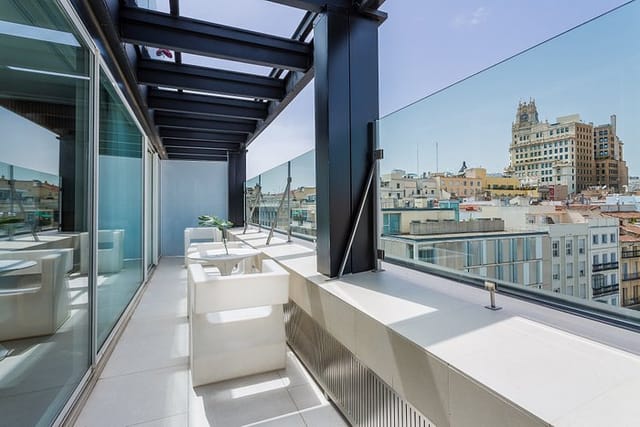 Modern rooftop terrace at Room Mate Óscar for corporate retreats and networking events.