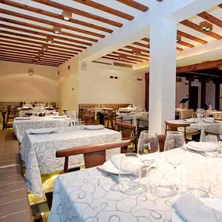 Rustic-chic banquet hall with wood beams for corporate dinners and networking events.