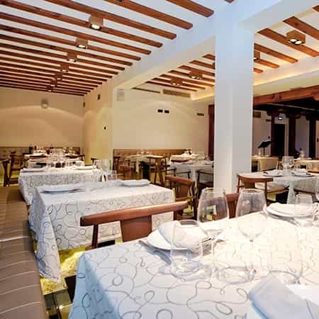 Rustic-chic banquet hall with wood beams for corporate dinners and networking events.