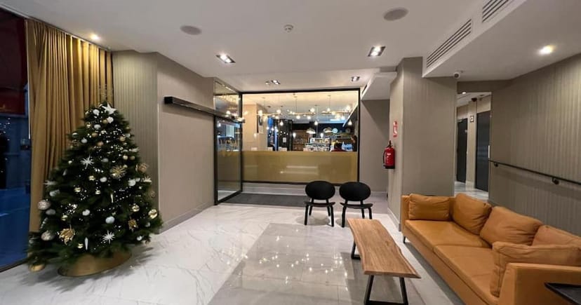 Modern hotel lounge breakout area for corporate networking and event registration.