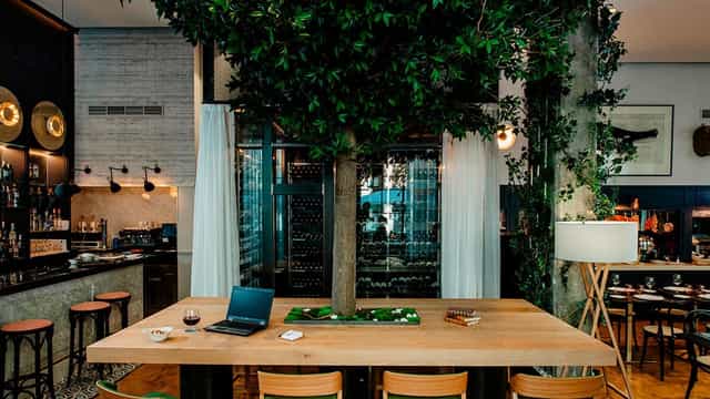 Biophilic hotel dining area for corporate breakout sessions and professional networking events.