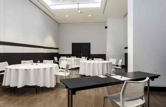 Modern breakout meeting room at ILUNION Suites Madrid for corporate events and classroom training.